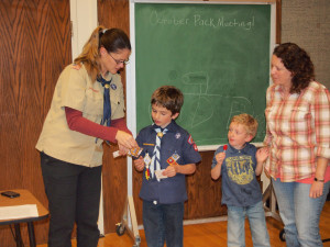 His den leader, Sis. Yancey, awarding his Bear and Whittling Chip. 